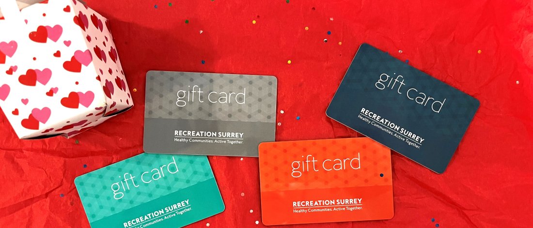 One blue, one navy blue, one grey and one orange gift card on a red background.