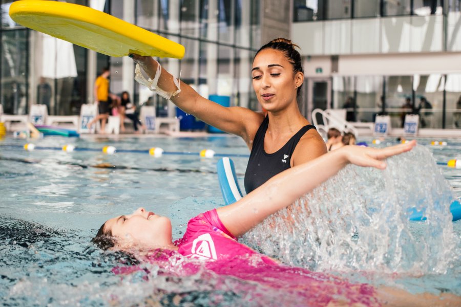 An instructor teaching swim lessons. 