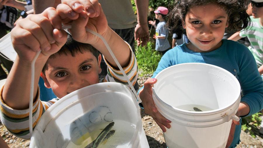Kids with buckets for fish release