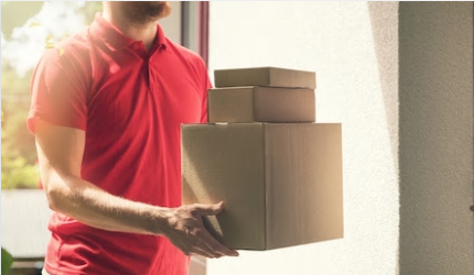 Man in red tshirt delivers boxes to home
