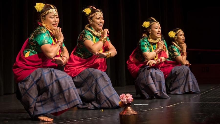 four women from Nepali perform on stage