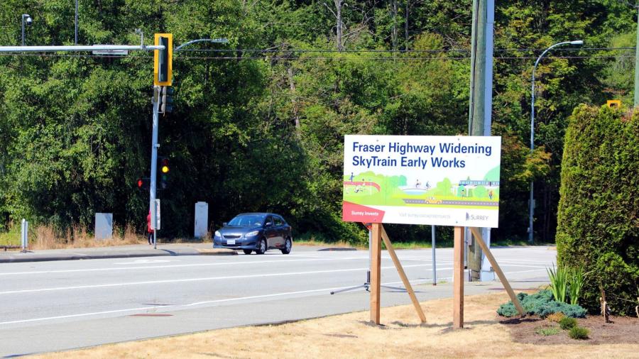 A road sign that reads "Fraser Highway Widening: SkyTrain Early Works"