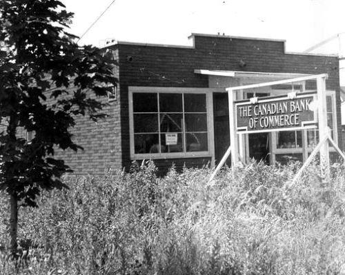 Black and white photo of a house with a Canadian Bank of Commerce sign