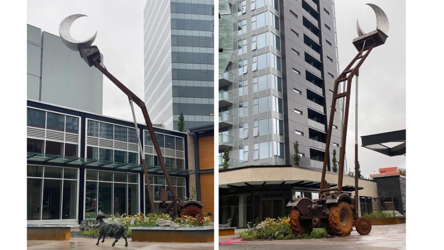 Two photographs of a public art sculpture of a brown tractor lifting up a silver moon with a sheep on the ground below, looking up at it.