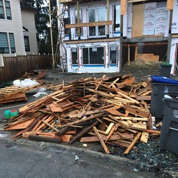 A pile of scrap wood outside a home