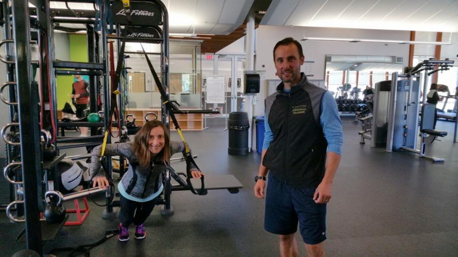 A patron working out with a personal trainer. 