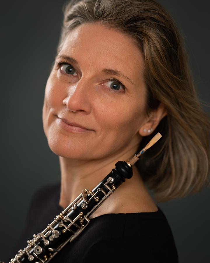 Emma Ringrose smiles at the camera holding her oboe