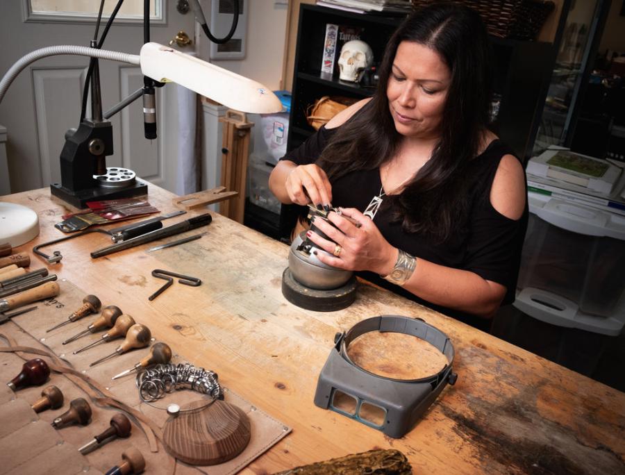 Phyllis Atkins designing jewelry in a studio
