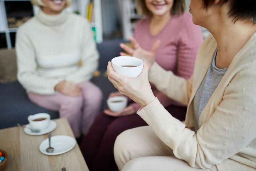 A group of women drinking tea and coffee